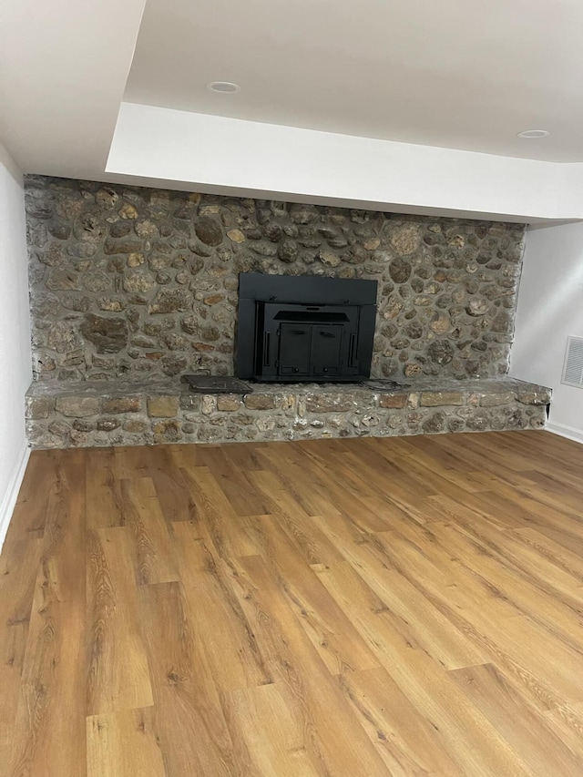 interior details featuring baseboards, visible vents, and wood finished floors