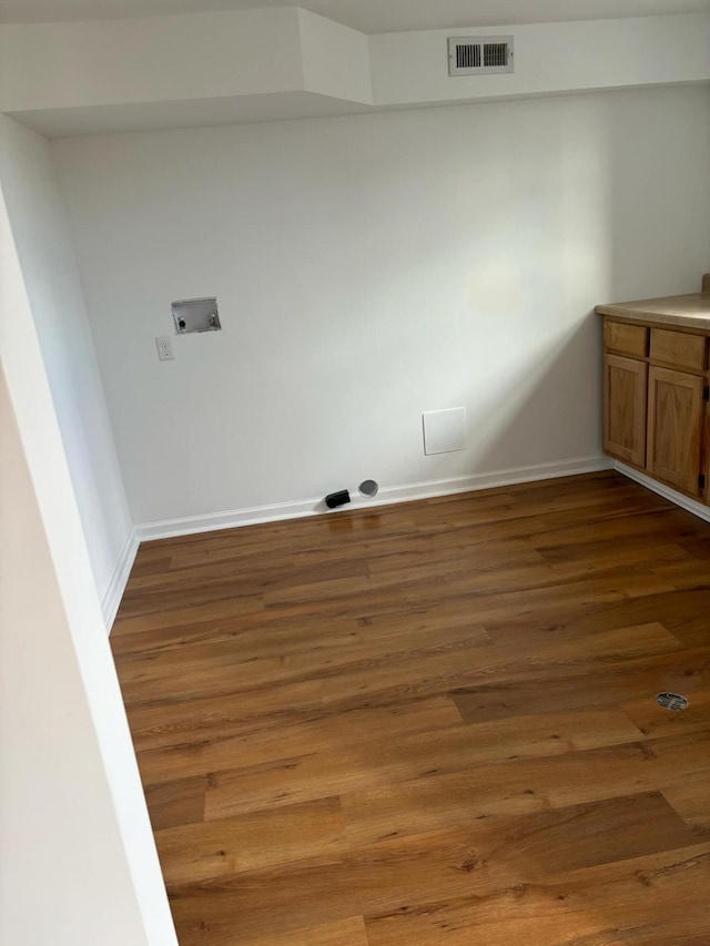 laundry room featuring laundry area, baseboards, visible vents, wood finished floors, and washer hookup