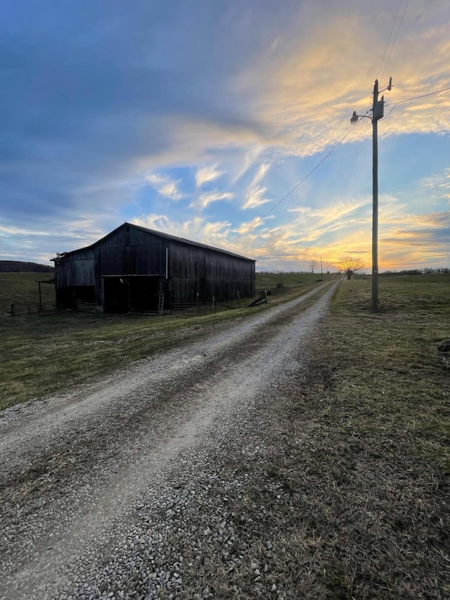 view of road featuring an outbuilding