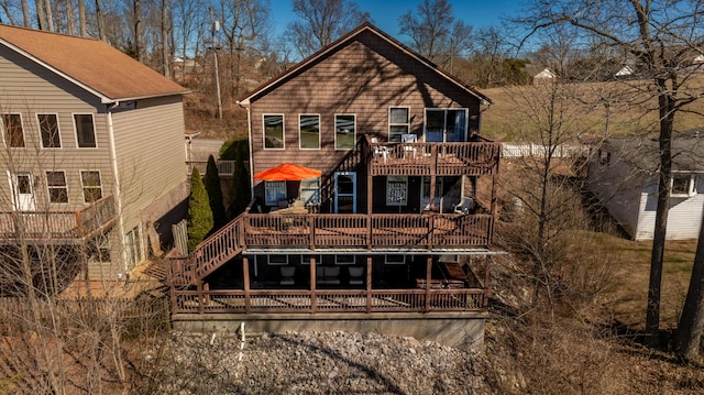 rear view of property featuring stairway and a deck