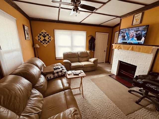 living area featuring carpet, a fireplace, ornamental molding, a ceiling fan, and vaulted ceiling