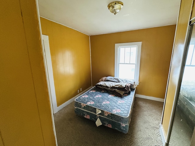 bedroom featuring carpet and baseboards