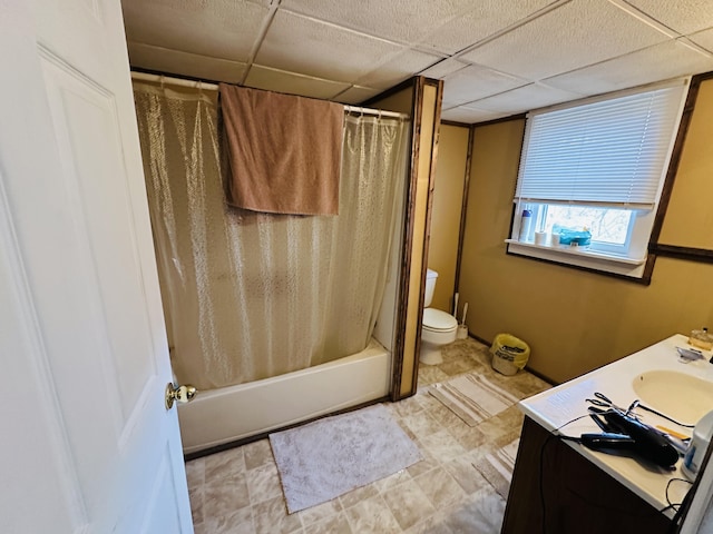 bathroom with toilet, shower / bath combo with shower curtain, a paneled ceiling, and vanity