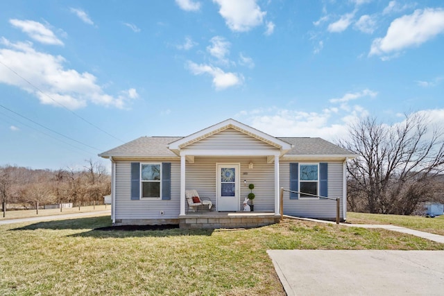 bungalow-style home featuring a porch, a front yard, and a shingled roof