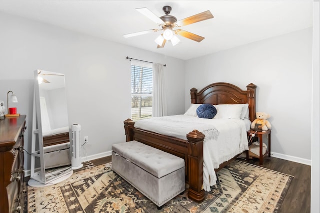 bedroom featuring wood finished floors, baseboards, and ceiling fan