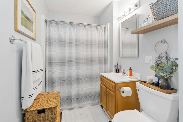 full bath featuring curtained shower, toilet, and vanity