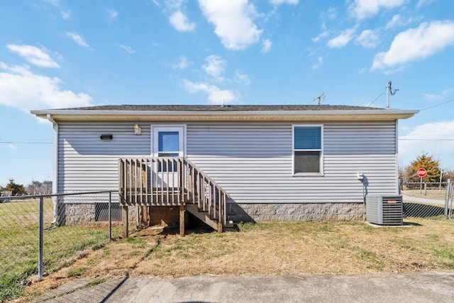 back of house with cooling unit and fence