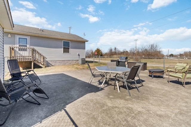 view of patio / terrace featuring grilling area, a fire pit, fence, cooling unit, and outdoor dining area