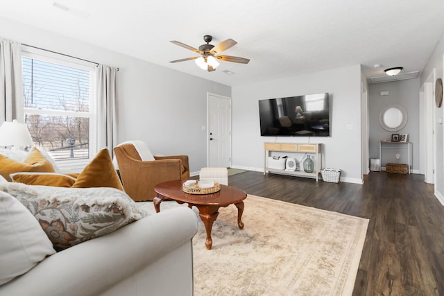 living room featuring dark wood finished floors, baseboards, visible vents, and ceiling fan