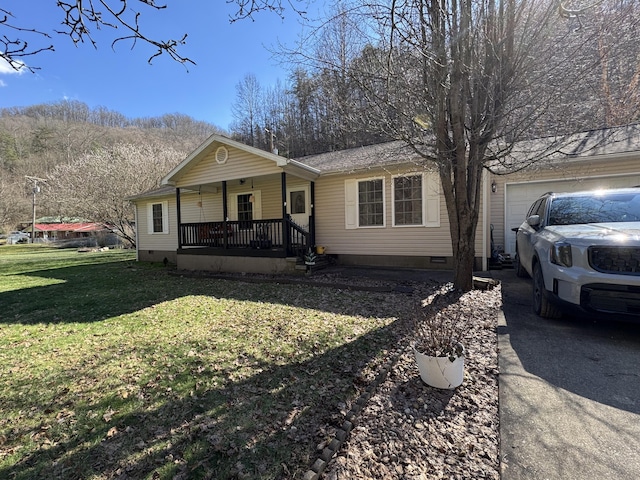 view of front of property featuring aphalt driveway, covered porch, an attached garage, crawl space, and a front lawn