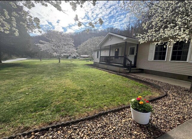 single story home with a porch, crawl space, and a front yard