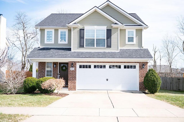 traditional home featuring a garage, fence, concrete driveway, and brick siding