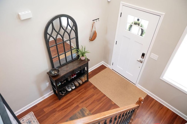 entryway with wood finished floors and baseboards