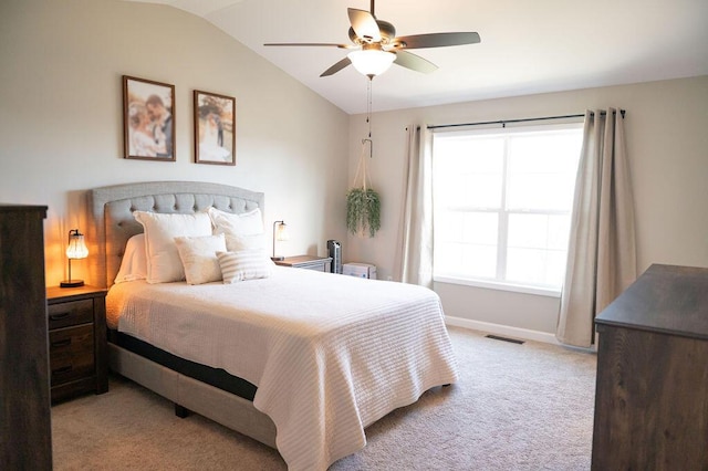 bedroom featuring ceiling fan, light carpet, visible vents, baseboards, and vaulted ceiling