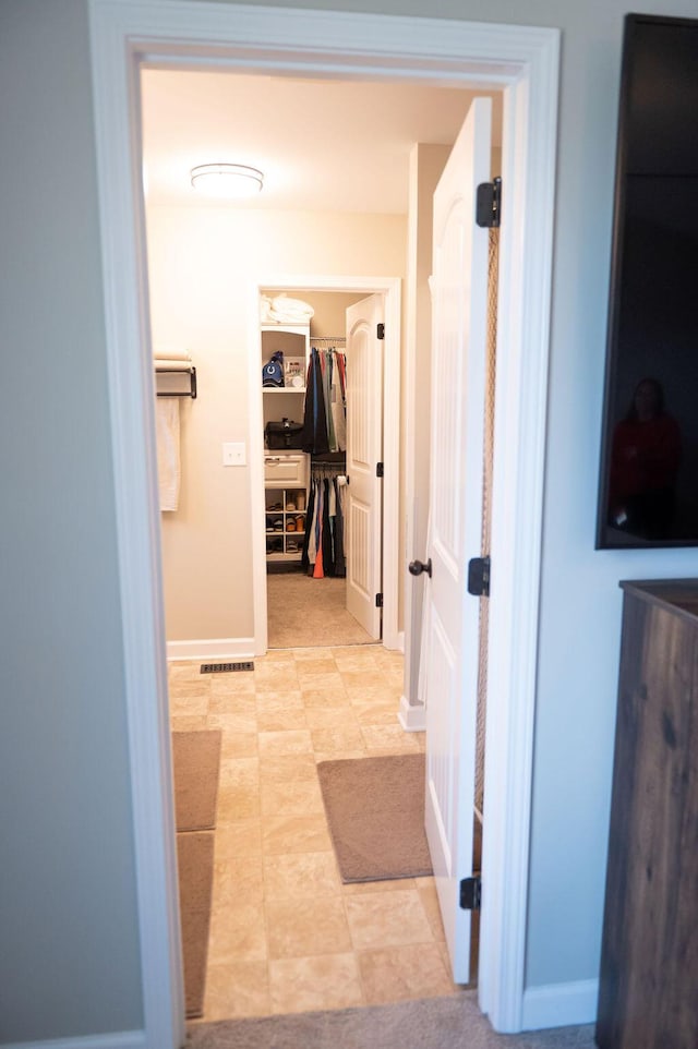 hallway featuring baseboards