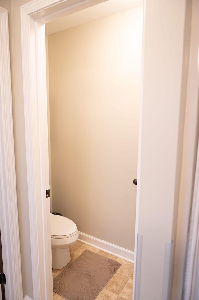 bathroom featuring toilet and baseboards