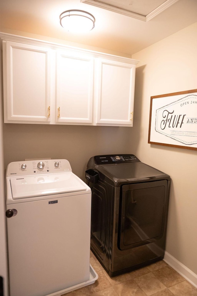 laundry room with washer and dryer, cabinet space, and baseboards