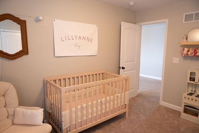 bedroom with a nursery area, baseboards, visible vents, and carpet flooring