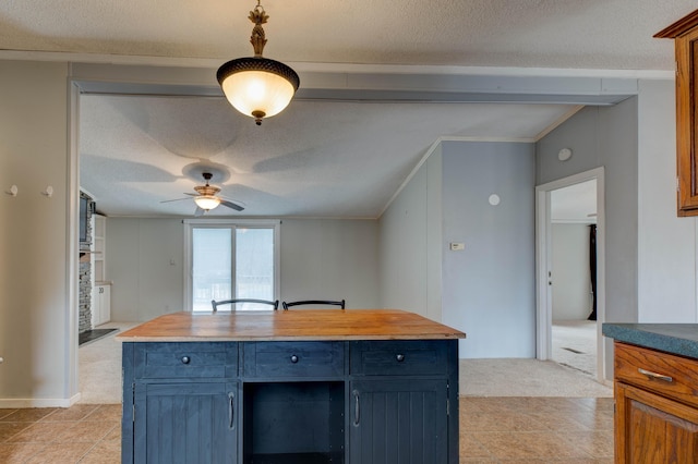 kitchen featuring light carpet, wood counters, crown molding, a textured ceiling, and blue cabinetry