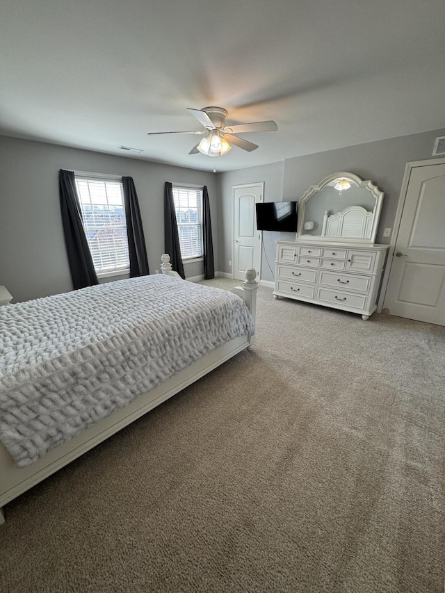 bedroom featuring visible vents, carpet floors, and a ceiling fan