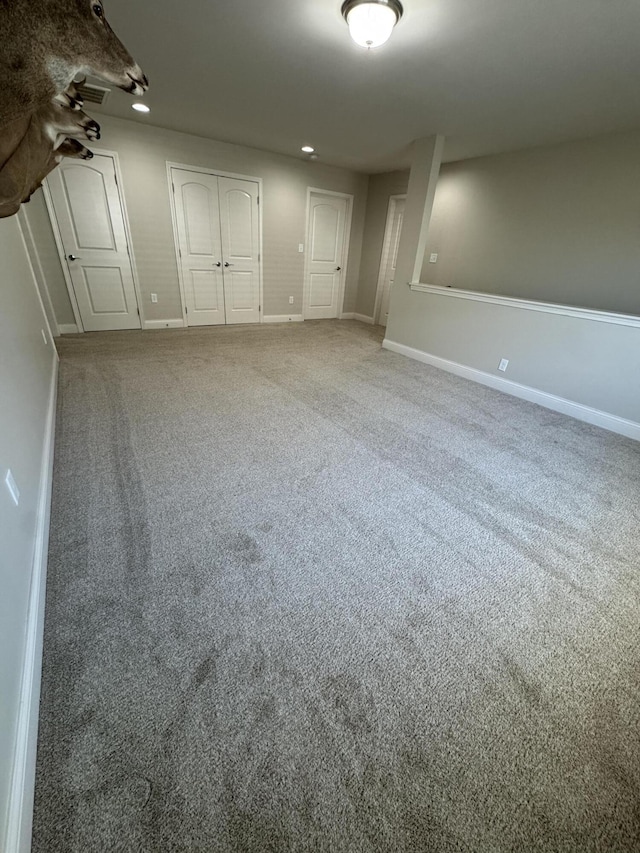 interior space featuring carpet flooring, recessed lighting, baseboards, and a closet