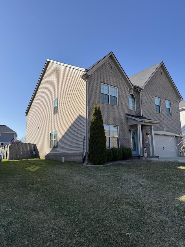 view of front of house featuring a garage, brick siding, a front yard, and fence