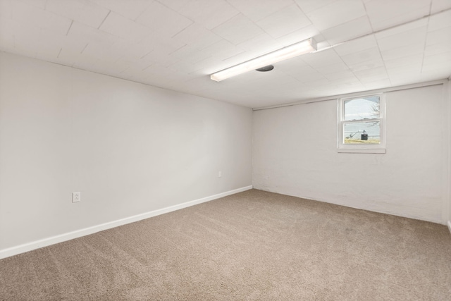 below grade area featuring carpet floors and baseboards