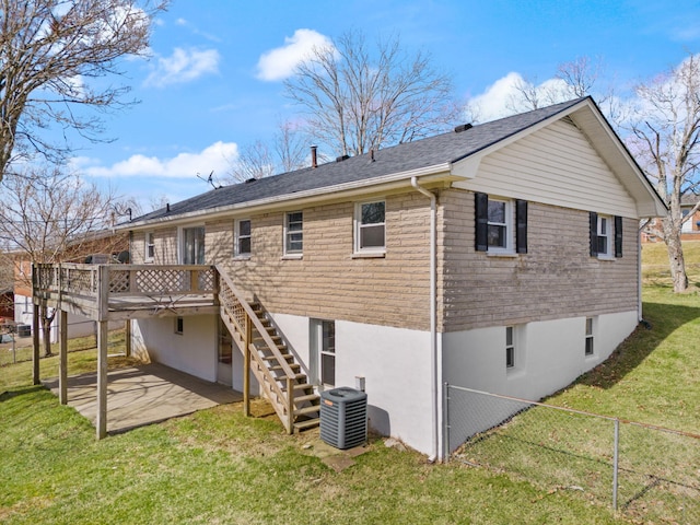 rear view of house with a patio, central AC, fence, a yard, and stairway