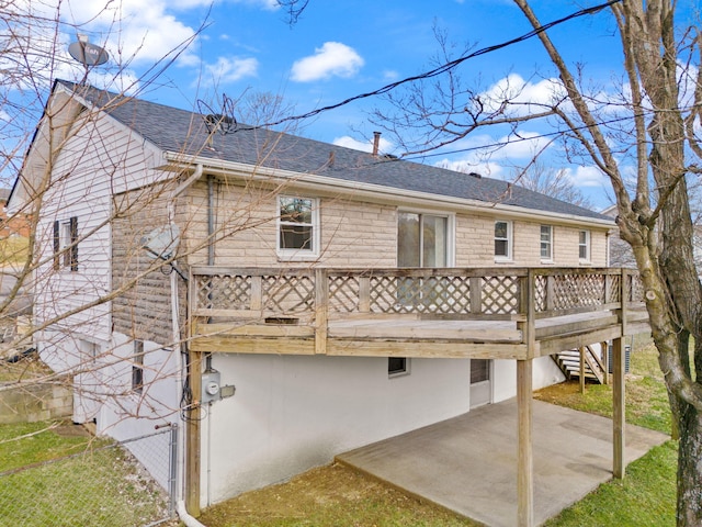 back of property featuring stairs, a patio area, a deck, and roof with shingles