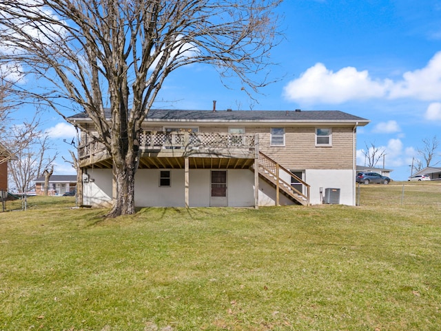 back of property with central air condition unit, stairs, a lawn, and a wooden deck