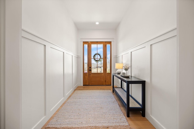 entryway with a decorative wall and light wood finished floors