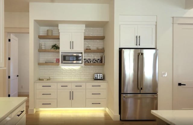 kitchen featuring white cabinetry, baseboards, appliances with stainless steel finishes, backsplash, and open shelves