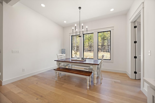 dining area featuring baseboards, recessed lighting, light wood-type flooring, and a notable chandelier