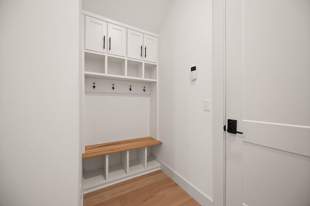 mudroom featuring baseboards and light wood finished floors