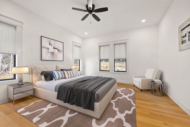 bedroom featuring baseboards, ceiling fan, wood finished floors, and recessed lighting