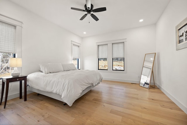 bedroom with baseboards, light wood finished floors, a ceiling fan, and recessed lighting