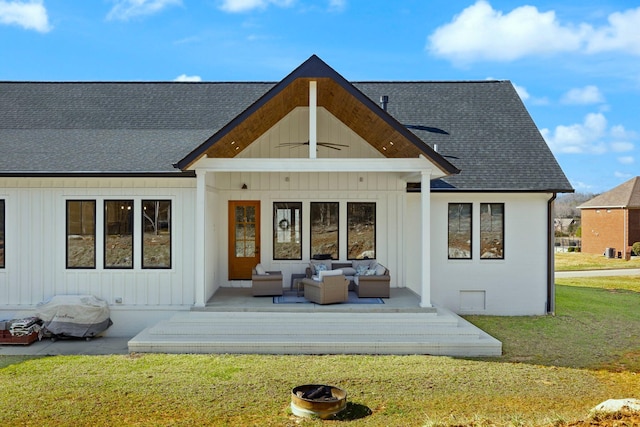 rear view of house with an outdoor hangout area, a ceiling fan, a yard, roof with shingles, and board and batten siding