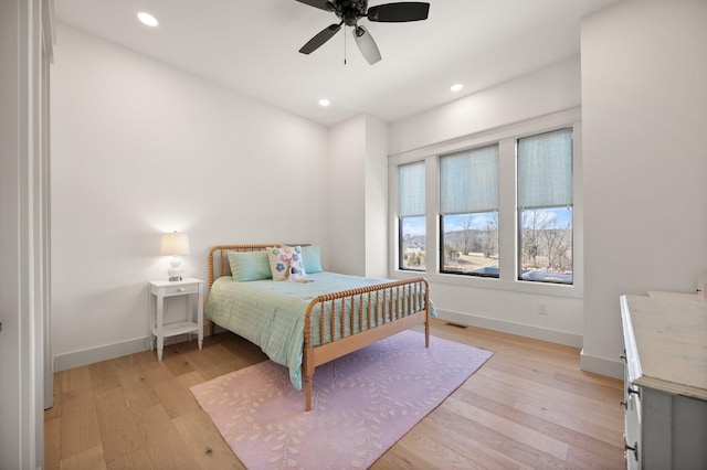 bedroom featuring light wood finished floors, recessed lighting, and baseboards