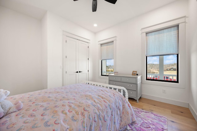 bedroom with baseboards, a ceiling fan, light wood-style floors, a closet, and recessed lighting