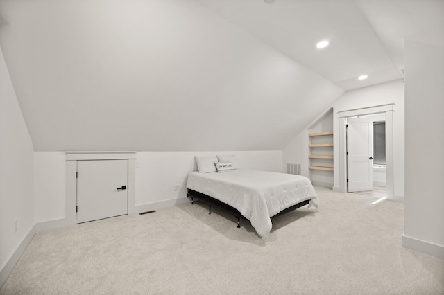 carpeted bedroom featuring vaulted ceiling, recessed lighting, visible vents, and baseboards