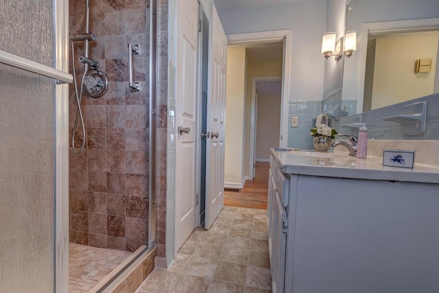 bathroom with a shower stall and vanity