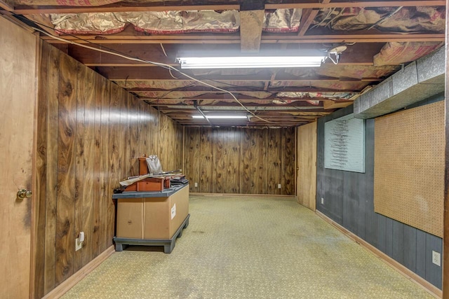 unfinished basement with carpet floors and wooden walls