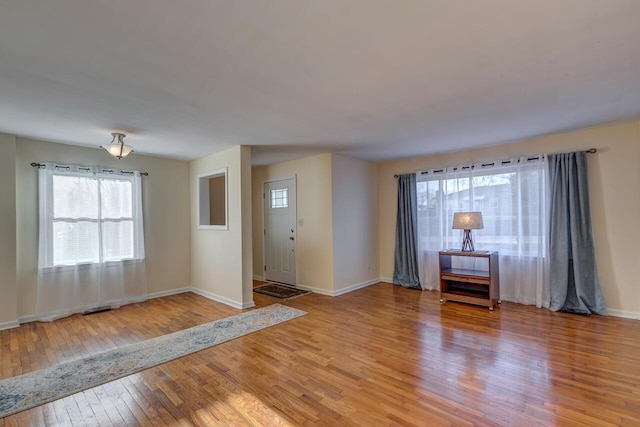 entrance foyer featuring baseboards and hardwood / wood-style flooring