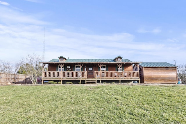 view of front of house featuring a porch, a front lawn, fence, and faux log siding