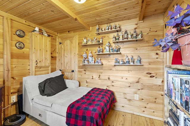 bedroom with wood ceiling, beam ceiling, wood walls, and wood finished floors