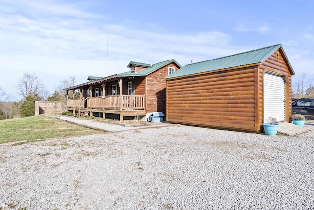 cabin with an outbuilding and metal roof