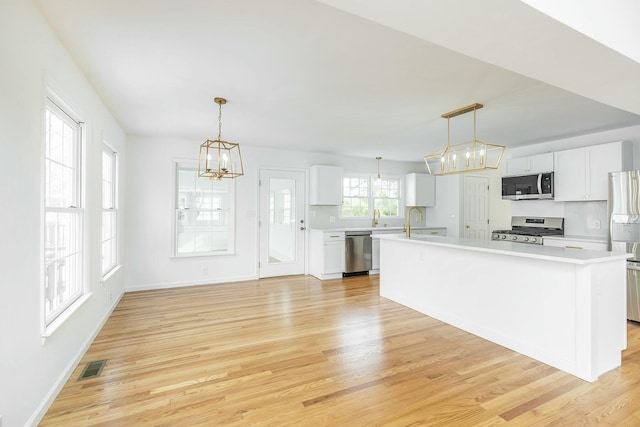 kitchen featuring visible vents, appliances with stainless steel finishes, light countertops, and light wood-style flooring