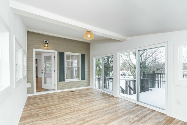 unfurnished sunroom with beamed ceiling