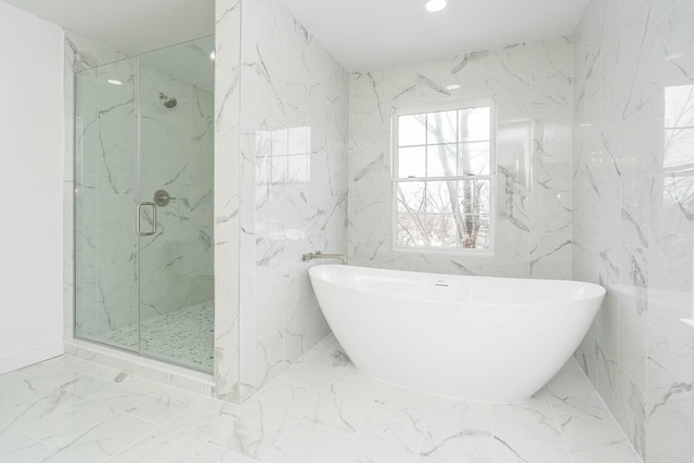 full bathroom with marble finish floor, a soaking tub, a marble finish shower, and recessed lighting