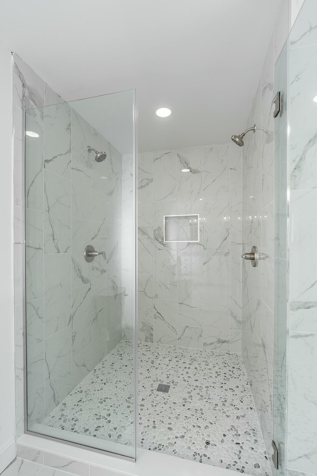 full bathroom with marble finish floor and a marble finish shower